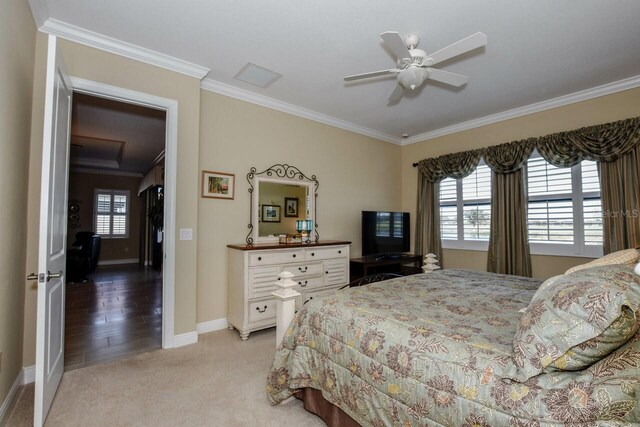 bedroom with light colored carpet, ceiling fan, and crown molding