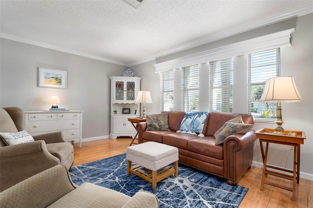 living room with light hardwood / wood-style flooring, a textured ceiling, and ornamental molding