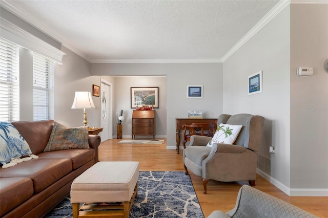 living room featuring ornamental molding, a textured ceiling, and light hardwood / wood-style flooring