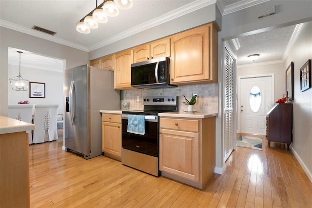 kitchen featuring crown molding, light hardwood / wood-style flooring, light brown cabinetry, decorative light fixtures, and stainless steel appliances