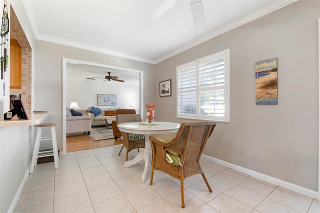 dining room with ceiling fan, light tile patterned floors, and crown molding