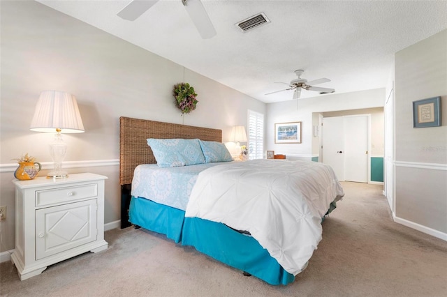 bedroom featuring ceiling fan and light carpet