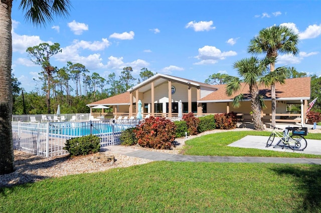 view of swimming pool featuring a yard and a patio