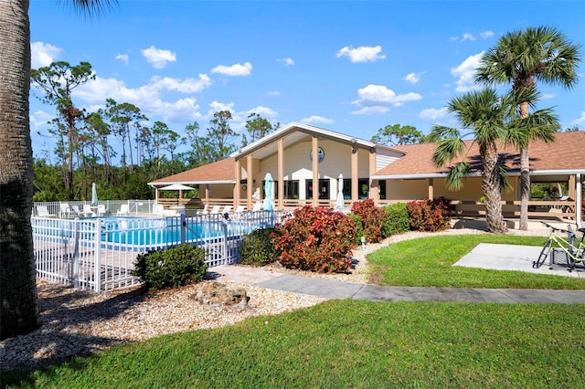 view of swimming pool with a patio area and a yard