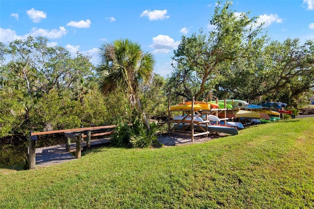 view of dock featuring a lawn