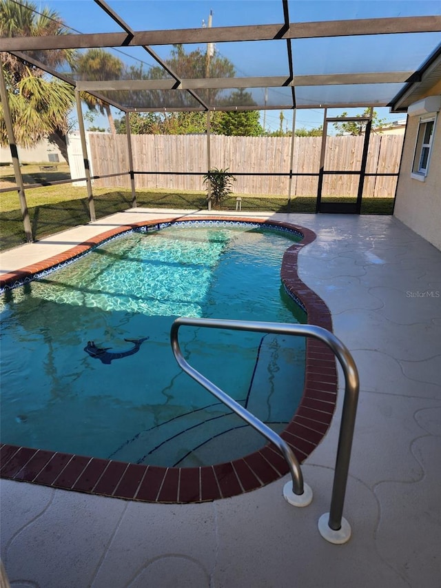 view of pool with a patio and a lanai