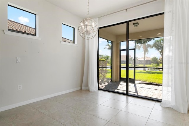 interior space with light tile patterned floors and a notable chandelier