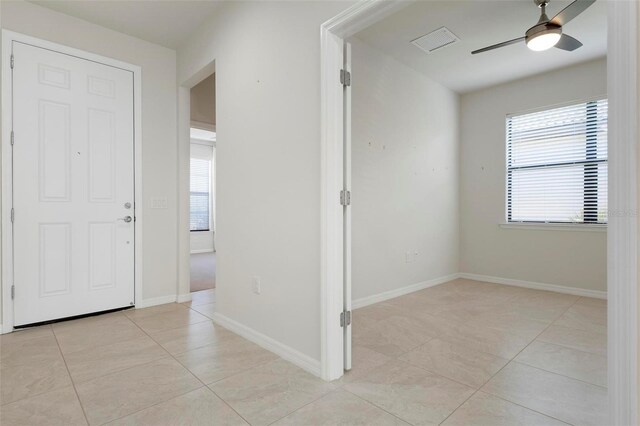 corridor with light tile patterned floors