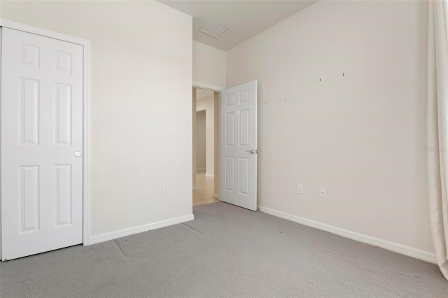 unfurnished bedroom featuring light colored carpet