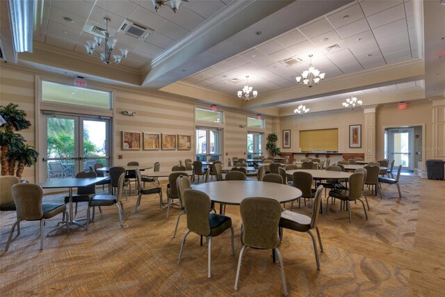 dining room with french doors, a wealth of natural light, crown molding, and wood-type flooring