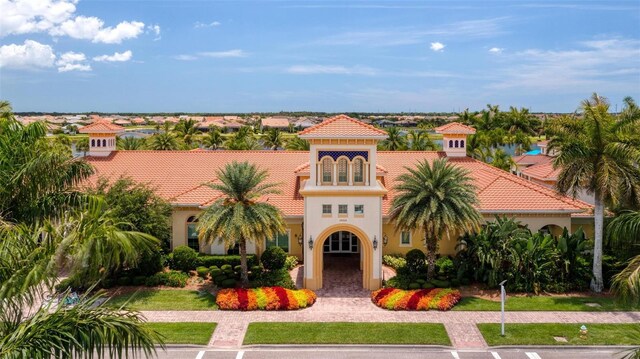 mediterranean / spanish house with a front lawn