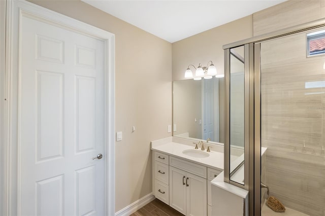 bathroom with hardwood / wood-style floors, vanity, and an enclosed shower