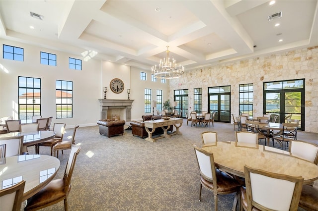 660 Ravello Blvd, Nokomis, FL 34275 - carpeted dining room featuring a towering ceiling, beamed ceiling, a premium fireplace, coffered ceiling, and a chandelier