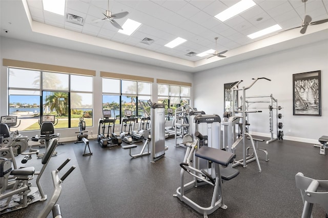 exercise room with a paneled ceiling and ceiling fan