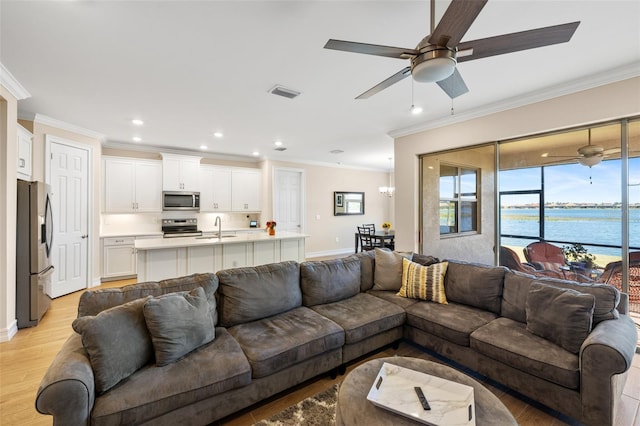660 Ravello Blvd, Nokomis, FL 34275 - living room with ornamental molding, ceiling fan, recessed lighting, a water view, and baseboards
