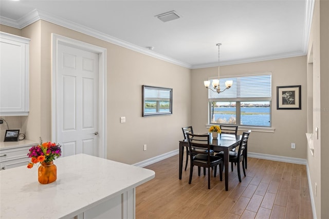 660 Ravello Blvd, Nokomis, FL 34275 - dining area with baseboards, a chandelier, light wood-type flooring, and crown molding