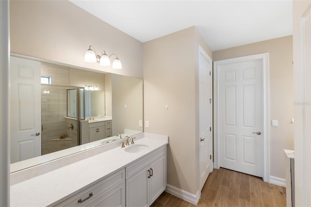 660 Ravello Blvd, Nokomis, FL 34275 - full bathroom with wood finished floors, baseboards, vanity, and tiled shower