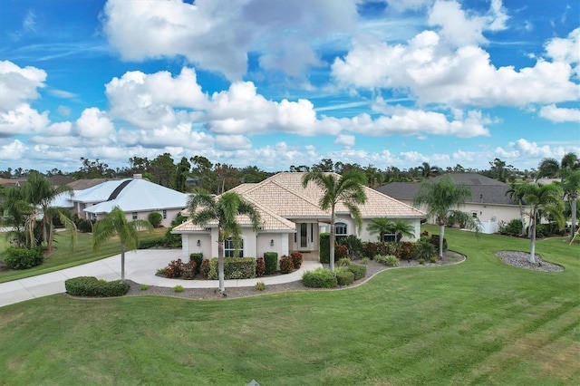 mediterranean / spanish-style house with a front lawn