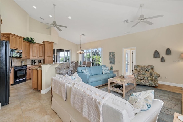 living room featuring ceiling fan with notable chandelier, light tile patterned floors, and high vaulted ceiling