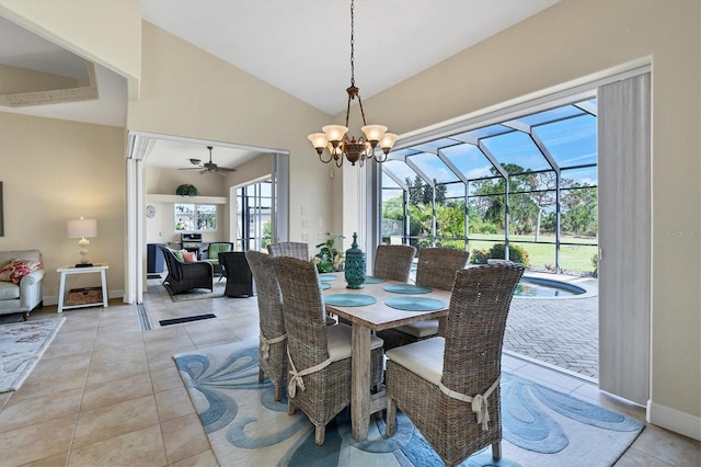 dining space with lofted ceiling, light tile patterned floors, and ceiling fan with notable chandelier