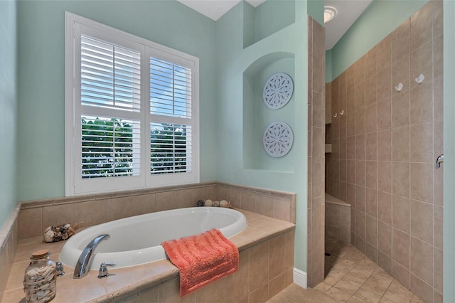 bathroom featuring plus walk in shower and tile patterned flooring