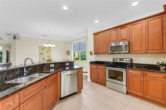 kitchen featuring sink, a notable chandelier, pendant lighting, appliances with stainless steel finishes, and ornamental molding