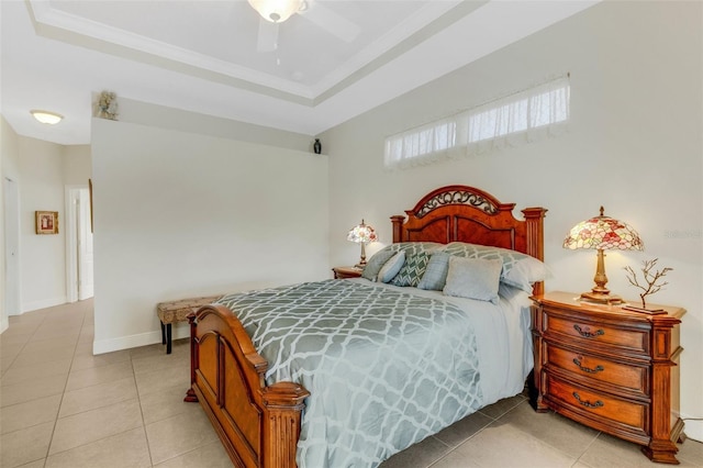 bedroom featuring a raised ceiling, ceiling fan, and light tile patterned floors