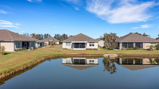 back of property featuring a water view