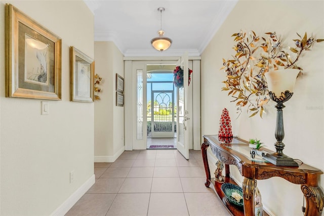 foyer entrance featuring light tile patterned floors and crown molding