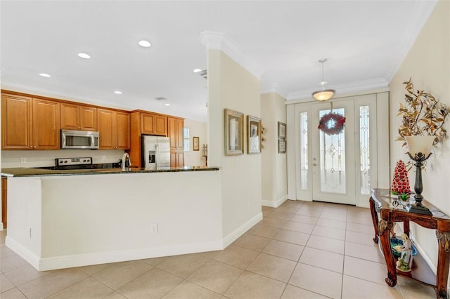 kitchen featuring sink, ornamental molding, appliances with stainless steel finishes, decorative light fixtures, and light tile patterned flooring