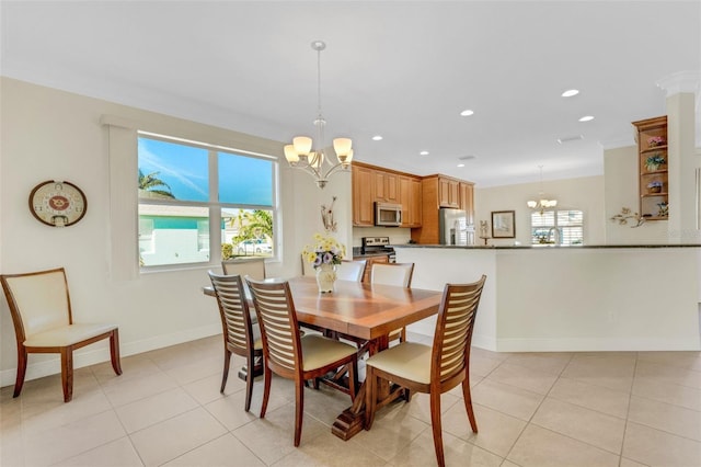 dining area with light tile patterned floors and an inviting chandelier