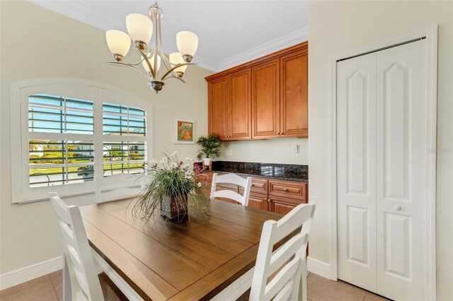 tiled dining area with ornamental molding and a notable chandelier