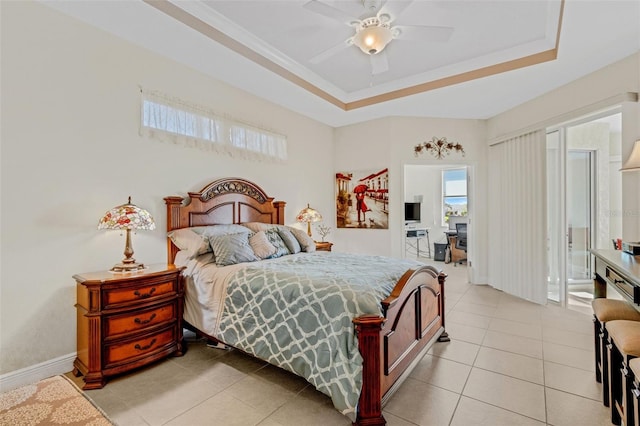 tiled bedroom with ceiling fan and a raised ceiling