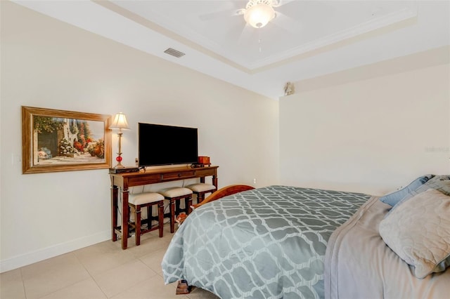 bedroom featuring ceiling fan, light tile patterned flooring, and a raised ceiling