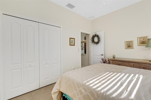 bedroom featuring light carpet and a closet