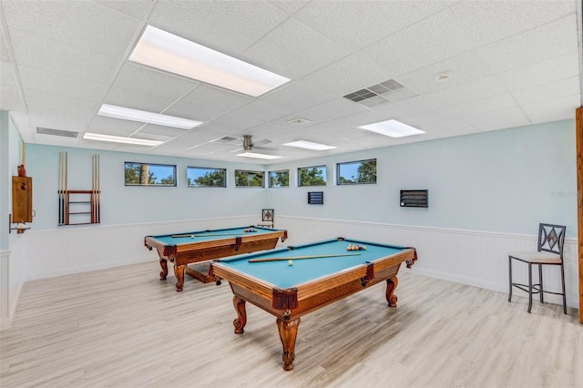 recreation room featuring ceiling fan, a drop ceiling, light hardwood / wood-style floors, and billiards