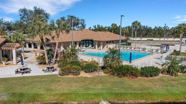 view of swimming pool with a patio area and a yard