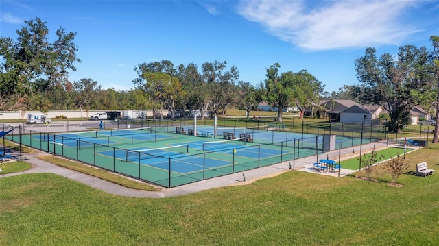 view of sport court with a lawn