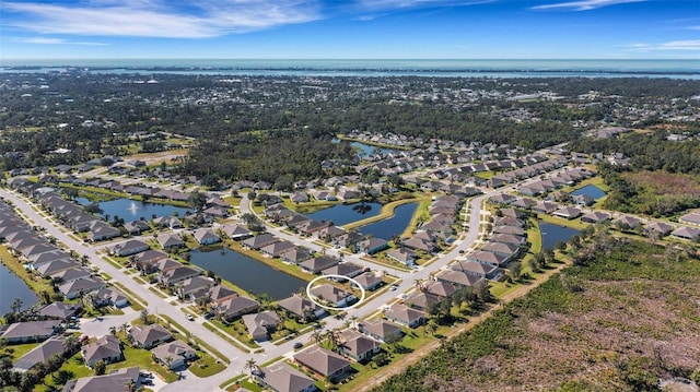 bird's eye view with a residential view and a water view