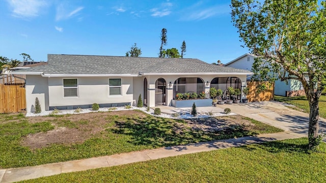 ranch-style home with a front lawn