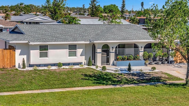 single story home featuring a front yard