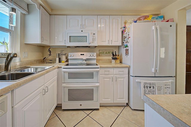 kitchen with white cabinetry, white appliances, sink, and light tile patterned floors