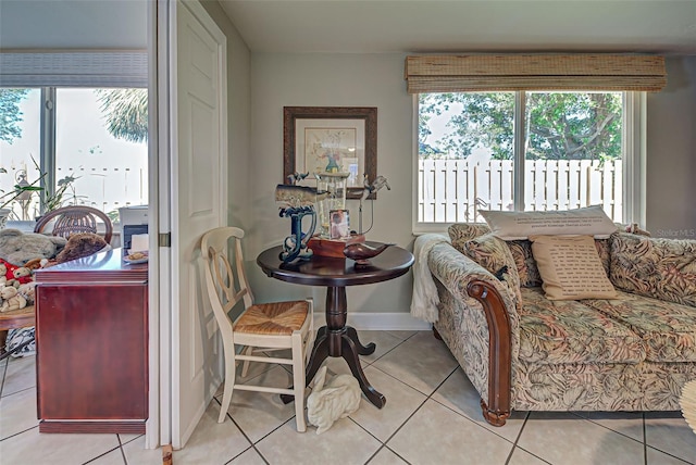 living room with plenty of natural light and light tile patterned floors