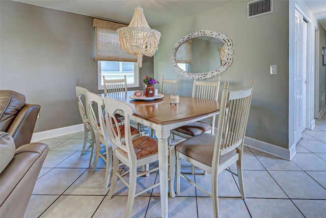 dining area with light tile patterned floors and a notable chandelier