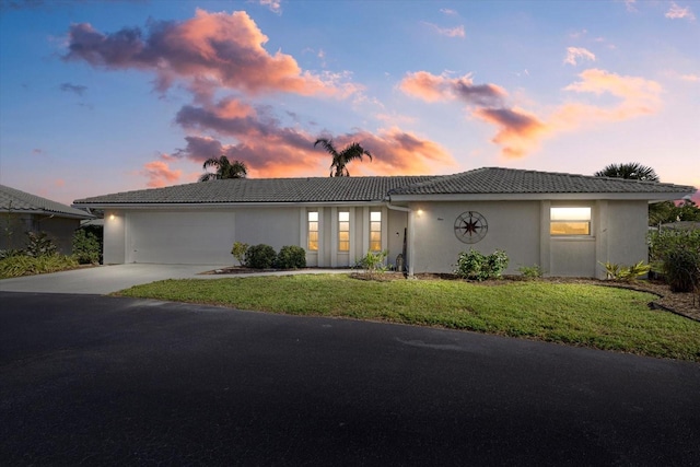 view of front facade with a lawn and a garage