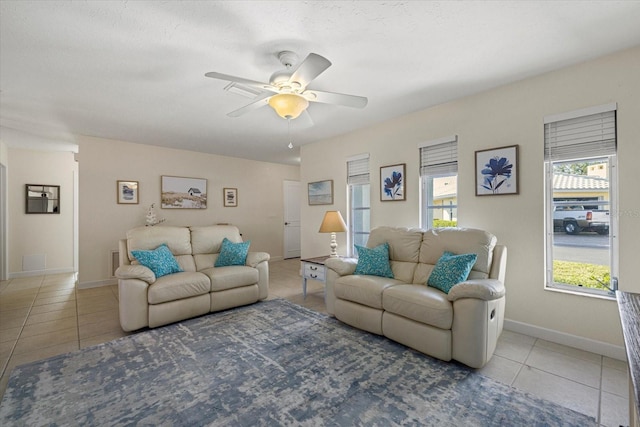 tiled living room with ceiling fan