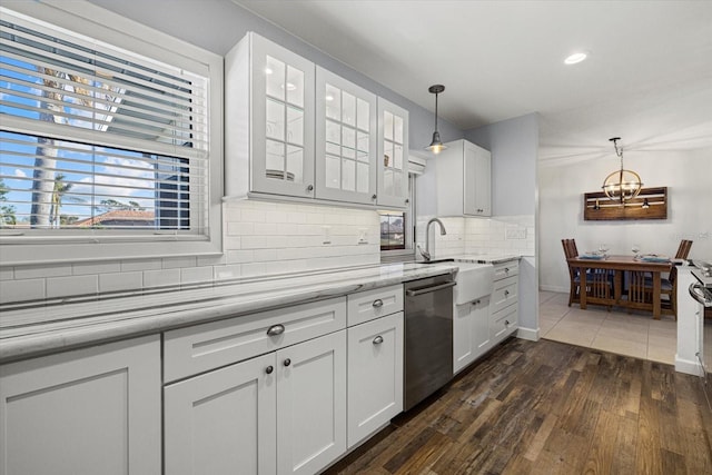 kitchen featuring decorative backsplash, stainless steel dishwasher, decorative light fixtures, white cabinets, and dark hardwood / wood-style floors