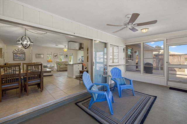 sunroom with ceiling fan with notable chandelier