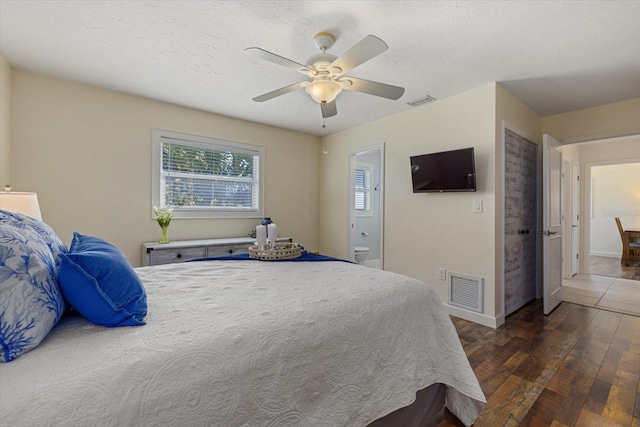 bedroom with dark hardwood / wood-style floors and ceiling fan