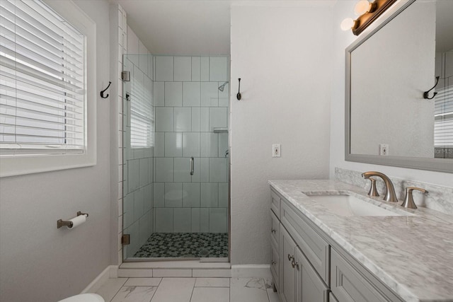 bathroom featuring vanity and a shower with shower door